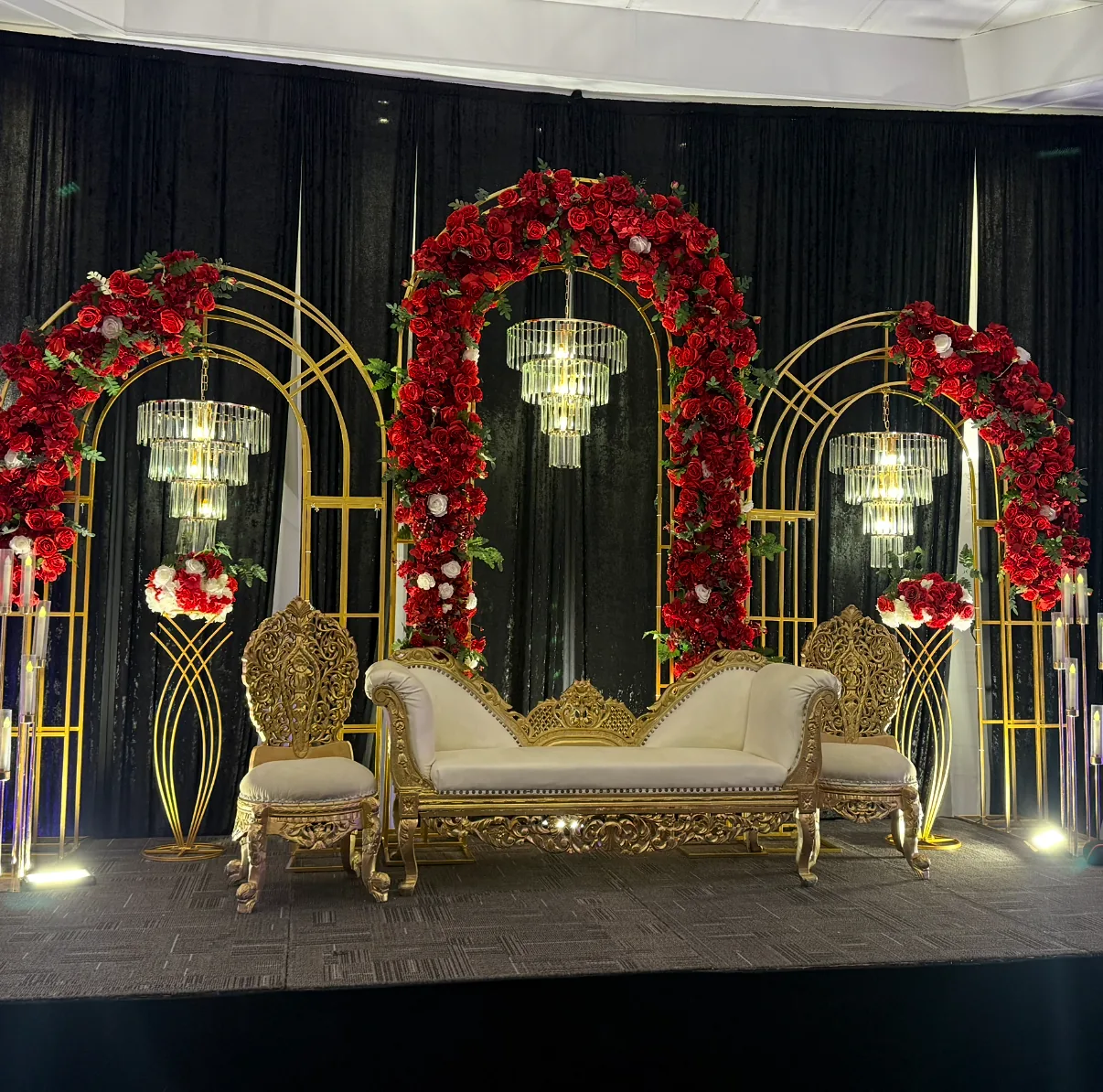 Elegant Buffalo wedding backdrop decor with floral accents and warm stage styling.
